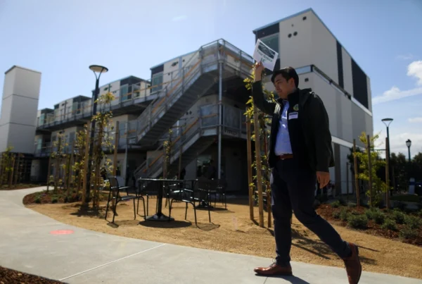 Kenny Chu of the San Mateo County Office of Community Affairs leads a tour of the San Mateo County Navigation Center on Tuesday, April 18, 2023, in Redwood City, Calif. The $57 million facility has 240 housing units, a dinning area, meeting space, laundry, and a dog run. (Aric Crabb/Bay Area News Group)