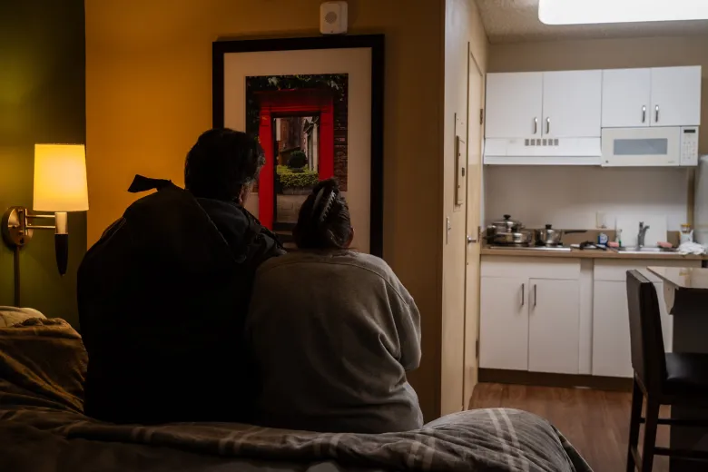 couple sitting on a bed
